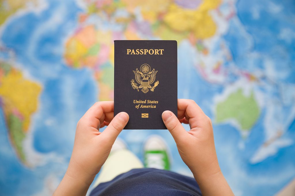 American passport over a map of the world